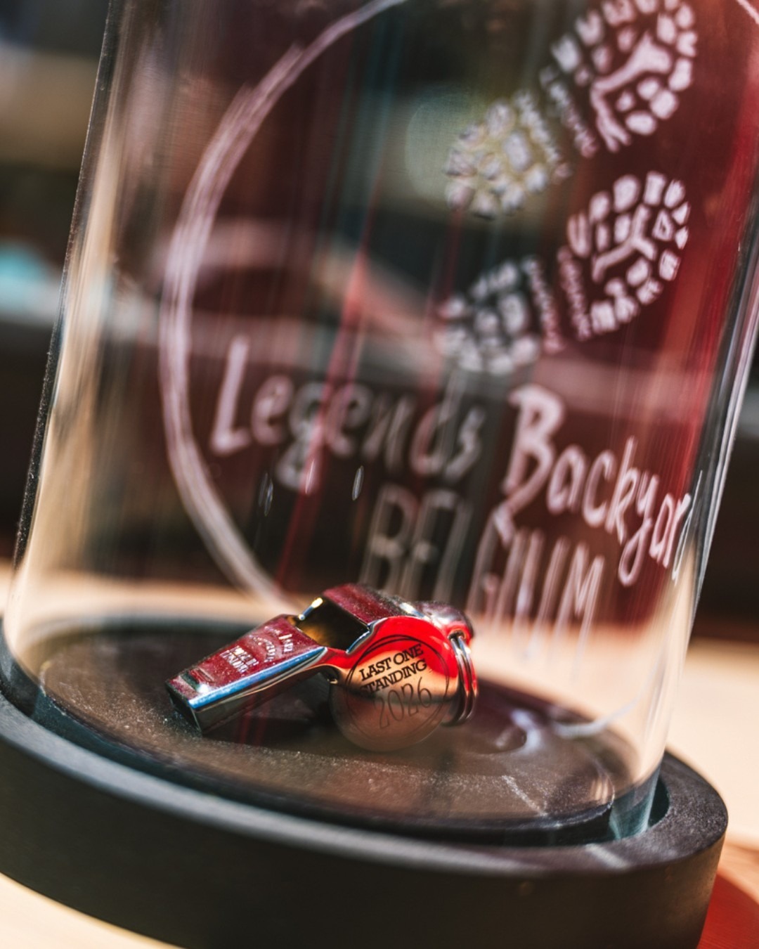 Whistle with text Last One Standing 2026 in a glass bulb that is engraved with the logo of Legends Backyard Belgium